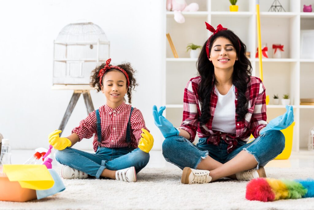 mother and daughter reducing stress in lotus pose