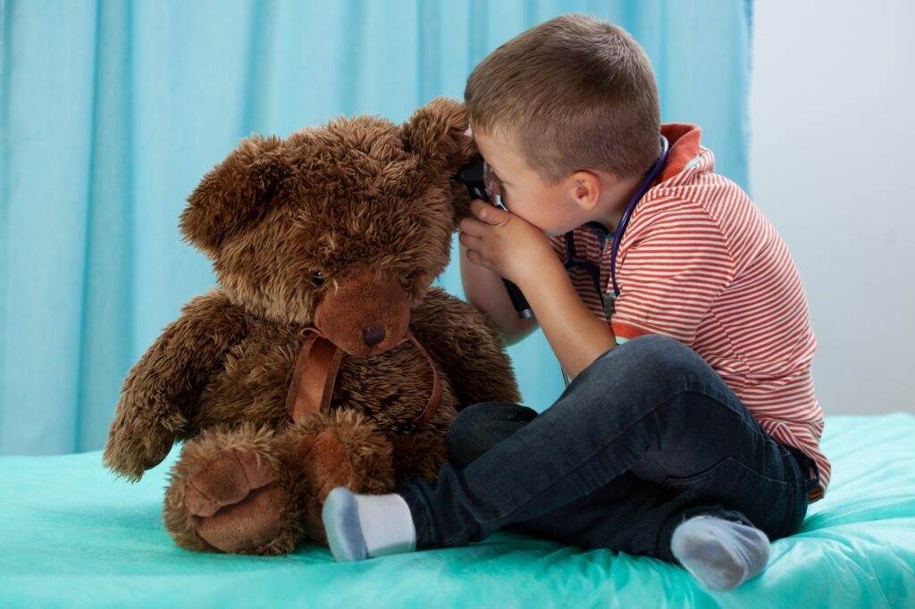 Boy Looking In Teddy Bears Ear Min